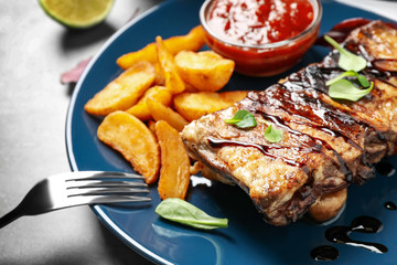 Delicious grilled ribs served on table, closeup