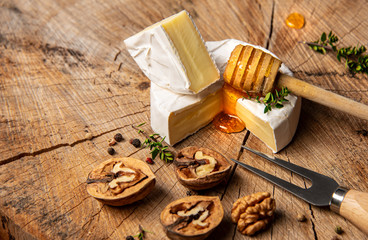 cheese and honey on old wooden table