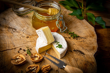 cheese and honey on old wooden table
