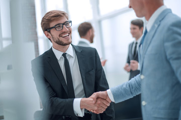 Fototapeta premium smiling businessman shaking hands with his business partner