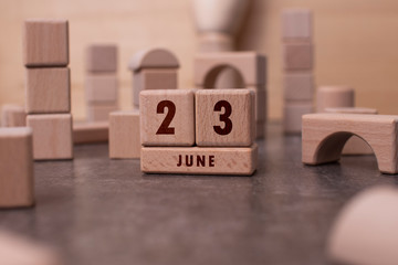 June 23 written with wooden blocks