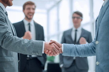 business partners shaking hands in the office