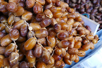 a large amount of fresh fresh dates, palm fruit sold in the shop,