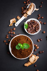 Mushroom Chaga Coffee Superfood Trend-dry and fresh mushrooms and coffee beans on dark background with mint. Coffee break