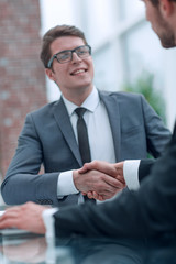 close up. young businessman and lawyer shaking hands.