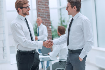 close up. business colleagues shaking hands in the office.