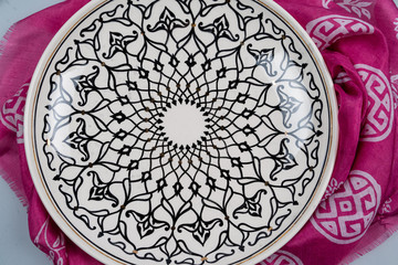 Decorative, painted plate on a kyalagai background.