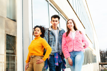 cute group of teenages at the building of university with books huggings, diversity nations real students lifestyle