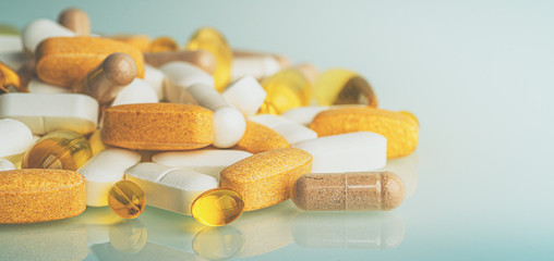 Dietary Supplements macro photo: multivitamin tablets, softgels with Omega-3 and Vitamin D3,...