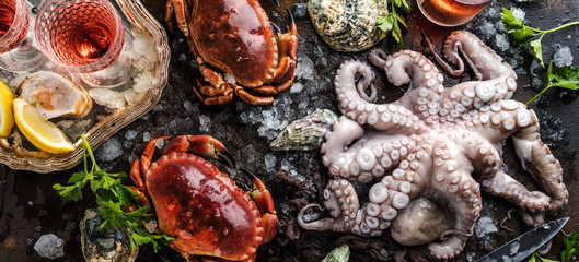 Zusammenstellung von Meeresfrüchten mit feinschmeckerischem Abendessenhintergrund der rohen frischen Krake,austern und mit roten krabben
