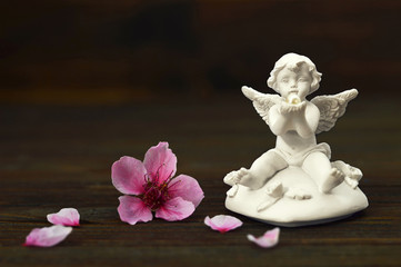Angel with pearl and spring flower