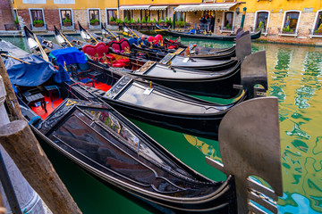 Narrow canal with gondola and bridge in Venice, Italy. Architecture and landmark of Venice. Cozy cityscape of Venice. © Aerial Film Studio