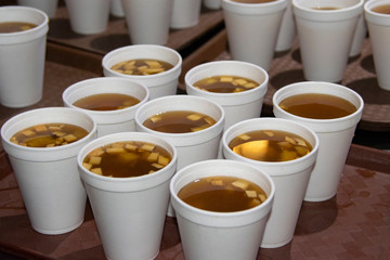  Disposable cup with hot drink made of fruits to celebrate Christmas in Guatemala, called Ponche.