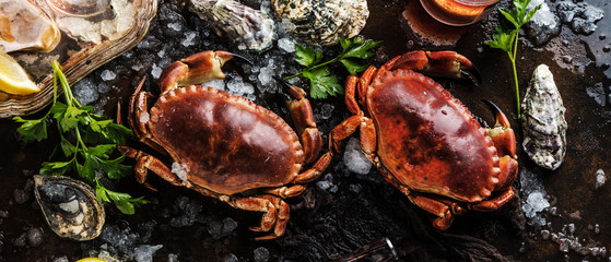 Assortment of seafood with raw fresh octopus gourmet dinner background, oysters and with red edible crab