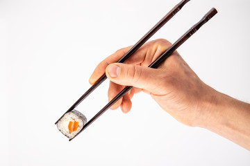 roll between chopsticks for sushi on a light background for the menu4