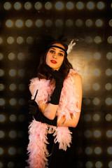 Roaring twenties poster flapper party girl, vintage Gatsby 20s fashion style ,make up and hairstyle. Soft Selective focus of model young woman, Caucasian girl Charleston party with feathers, art deco