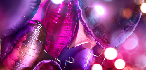 Air Balloons. Bunch of purple heart shaped foil balloons art design Holiday background. Love. Celebration. Valentine's Day purple, red, pink, blue backdrop. party decoration. Metallic balloon Birthday