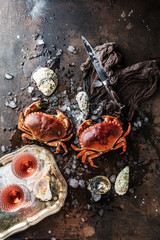 Assortment of seafood with raw fresh octopus gourmet dinner background, oysters and with red edible...