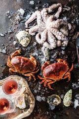 Assortment of seafood with raw fresh octopus gourmet dinner background, oysters and with red edible crab