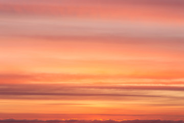 Dramatic soft sunrise, sunset orange yellow red sky with clouds background texture