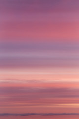 Dramatic soft sunrise, sunset pink violet sky with clouds background texture	