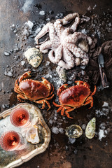 Assortment of seafood with raw fresh octopus gourmet dinner background, oysters and with red edible crab
