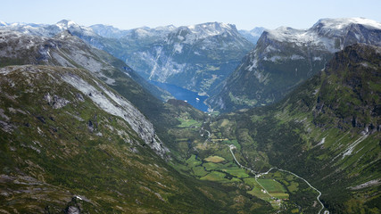 Geiranger fjord with boats green valley surrounded by mountains.  More og Romsdal county, Norway
