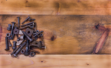 Working bench with rusty screws and bolts on the left side. Empty space on the right side. Top view.