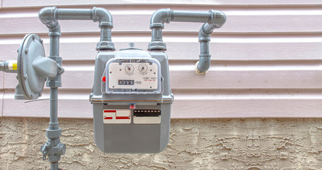 Residential urban natural gas meter measuring gas consumption, outside house gas meter