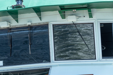 Fototapeta premium windows of a ferry boat reflecting and showing the view of the water