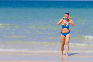 Fototapeta premium Woman and bikini blue pretty with sunlight on beach