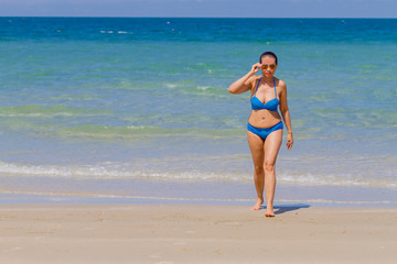 Fototapeta premium Woman with bikini blue idyllic with sunlight on beach