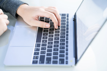 Fototapeta na wymiar Woman working at home office using laptop searching web, browsing information