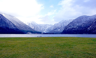 panorama of Hallstatt lake and green grass field outdoor