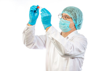 lab technician looks at a test tube of clear liquid, coronavirus
