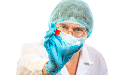 lab technician looks at a test tube of clear liquid, coronavirus