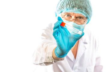 lab technician looks at a test tube of clear liquid, coronavirus