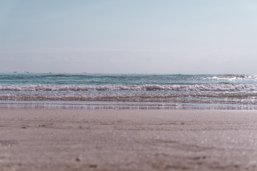 Tropical nature clean beach and white sand in summer with sun light blue sky and bokeh.