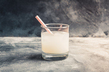 Old fahioned lychee cocktail on the rustic background. Selective focus. Shallow depth of field.