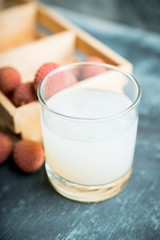 Old fahioned lychee cocktail on the rustic background. Selective focus. Shallow depth of field.