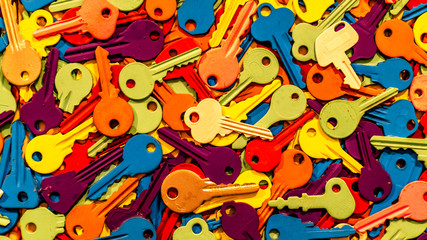 Fototapeta premium A whole bunch of colored keys on white background. Various colors. Close up background.