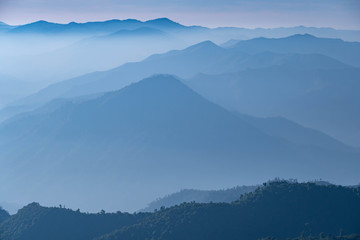 Mountain complex with misty or smoke pollution from wildfire during morning at the northern region of Thailand.