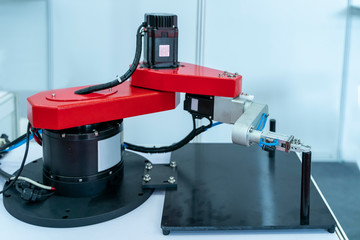 robotic arm handling the metal machined shaft parts between the production line. automotive parts manufacturing process.