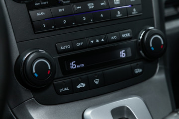 Close up Instrument automobile panel with  climat control view with air conditioning buttons- details and controls of modern car..
