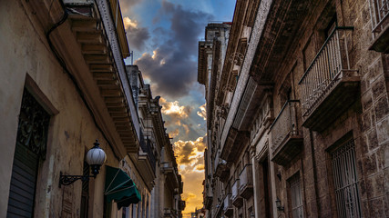 Havana, Cuba. Old colonial buildings with balconies against dramatic blue sky.