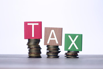 tax concept on wood blocks and coins