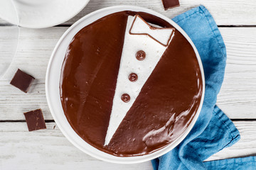 Cake with a pattern in the form of a jacket on a wooden background