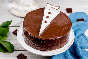 Cake with a pattern in the form of a jacket on a wooden background