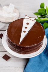 Cake with a pattern in the form of a jacket on a wooden background