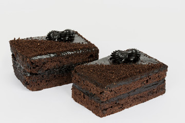 Two pieces of chocolate cakes on a white background